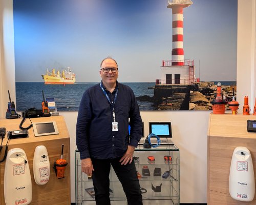 Jotron's Maritime Director in front of racks with the company's maritime products.