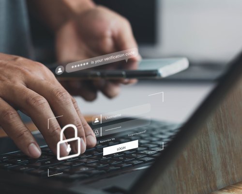 A photo illustrating cybersecurity, showing hands on a PC keyboard with login and security symbols displayed on the screen.