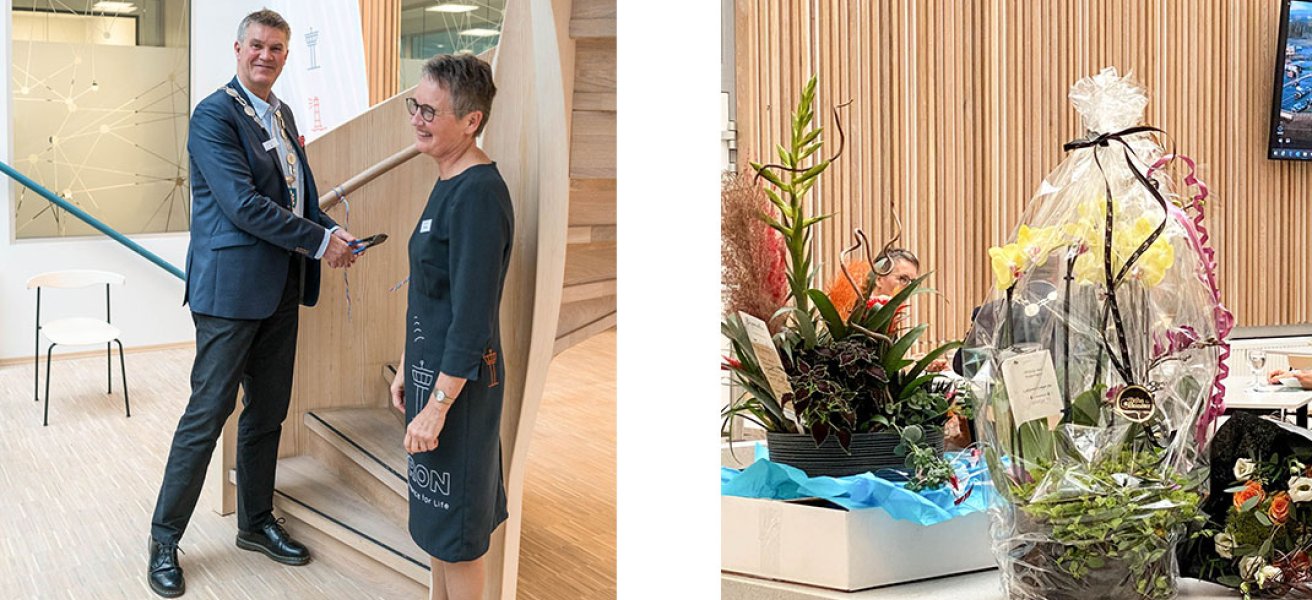 The Mayor of the city of Larvik Erik Bringedal and Merete Berdal open the new Jotron office, in front of a table with flowers and gifts.