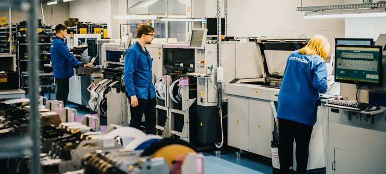 Jotron UAB employees working the production