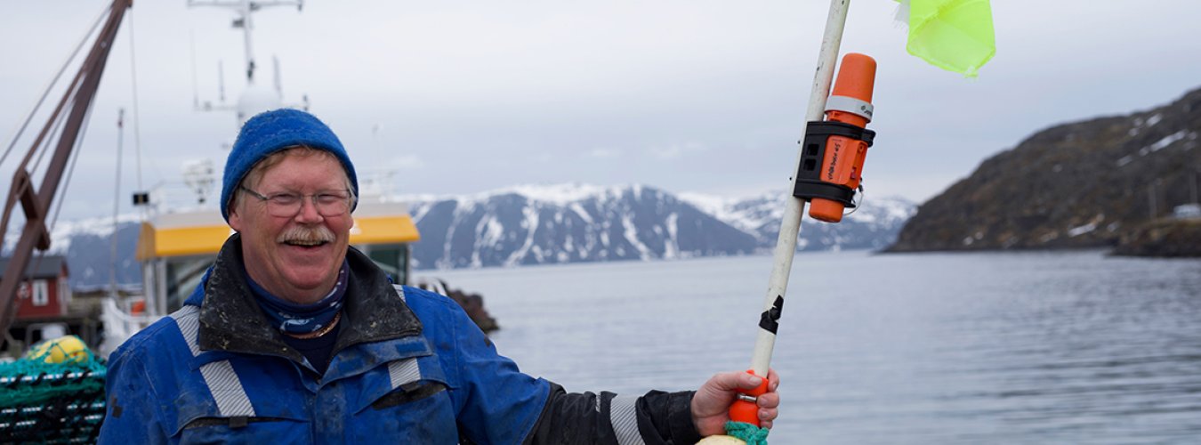 Fisherman holding TronTracker.